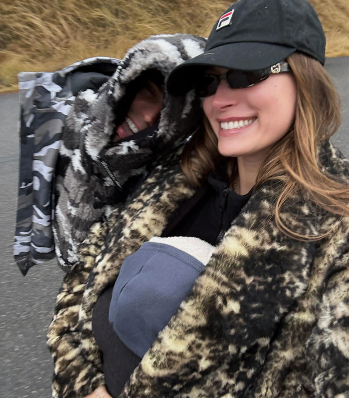 Two people bundled up in hooded camouflage and animal print jackets on a chilly day in Brooklyn. Two people bundled up in hooded camouflage and animal print jackets on a chilly day in Brooklyn.