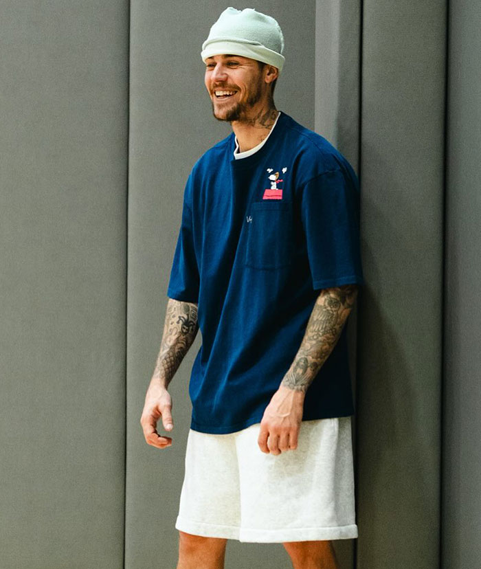 Man smiling in casual attire, wearing a beanie and standing against a wall, related to Justin Bieber health concerns. Man smiling in casual attire, wearing a beanie and standing against a wall, related to Justin Bieber health concerns.