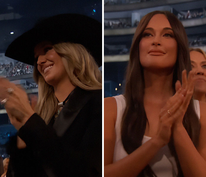 Two women clapping and smiling at the 2025 Grammy Awards, capturing an awkward yet celebratory moment.