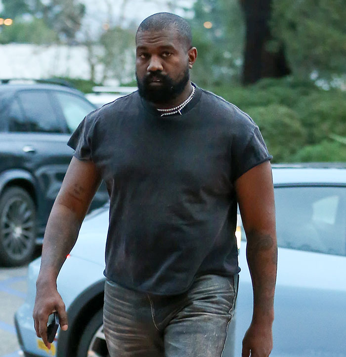 A person in a black shirt outside near parked cars, related to Bianca Censori's afterparty song discussion.