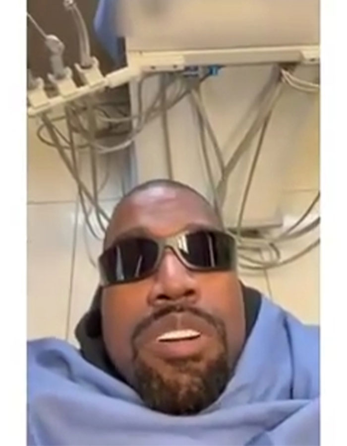 Kanye West in sunglasses under medical equipment, related to Super Bowl ad news.
