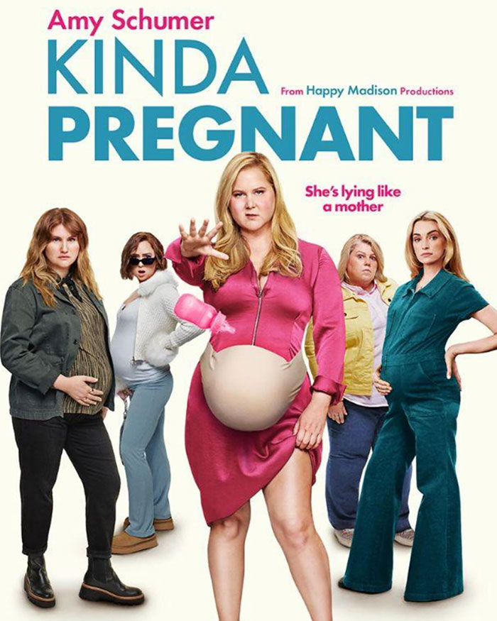 Amy Schumer in a comedic pose for "Kinda Pregnant" with a humorous group of characters and exaggerated baby bump.