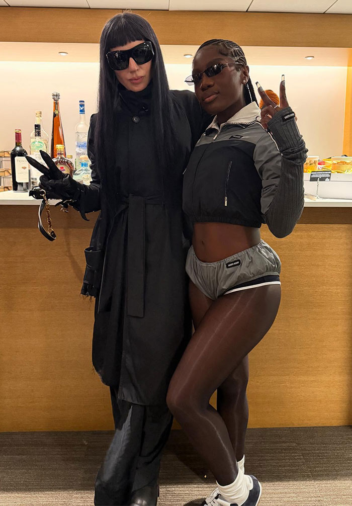 Two women in striking outfits with sunglasses, showcasing bizarre looks from the Super Bowl 2025 in a stylish setting.