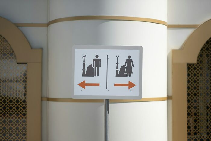 Restroom sign in foreign country, symbolizing culture shock experience.