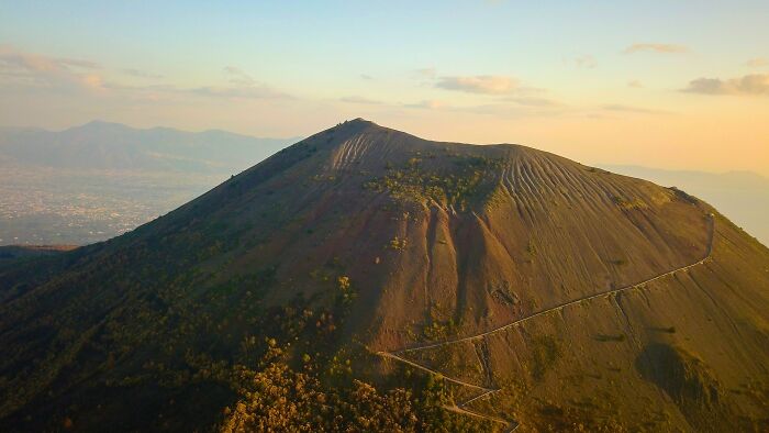 A breathtaking view of a natural wonder at sunrise, showcasing the mountain's textured landscape and winding path.