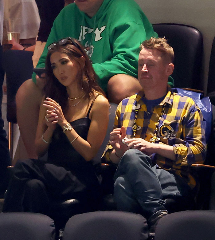 Two people in unique outfits attending Super Bowl 2025.