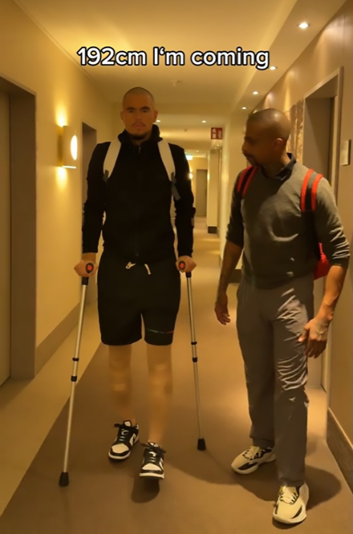 Leon Otremba using crutches to walk in a hallway, conveying insecurity and determination to reach 192cm height. Leon Otremba using crutches to walk in a hallway, conveying insecurity and determination to reach 192cm height.