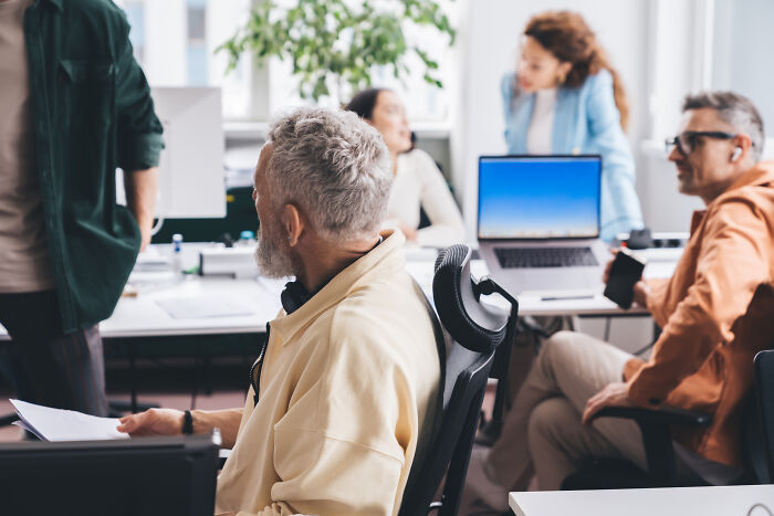 Office team in a casual meeting discussing ideas, capturing one of the insane workplace moments that got legendary status.