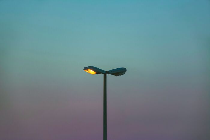Streetlight glowing at dusk against a gradient sky, symbolizing nostalgic moments like using songs as ringtones.