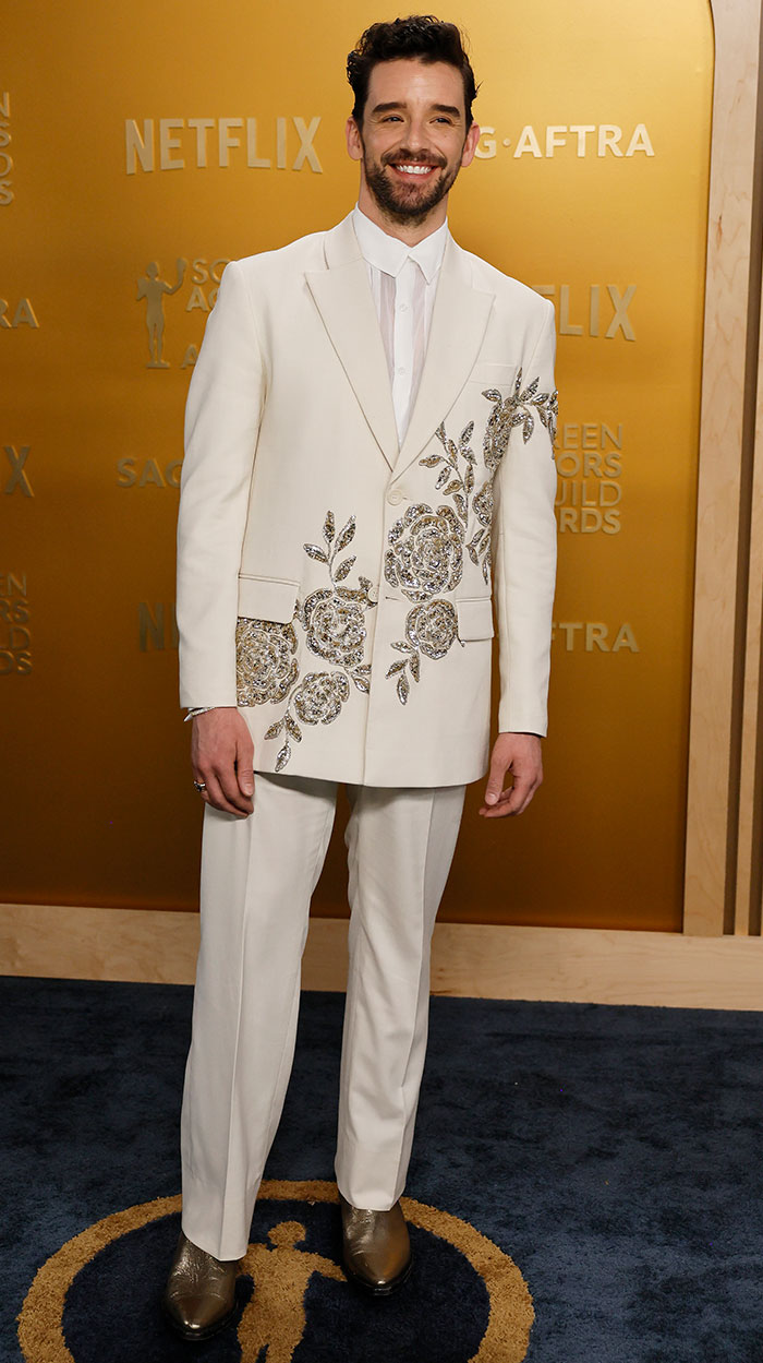 Michael Urie in an embellished white suit on the SAG Awards red carpet, noted for one of the worst looks.