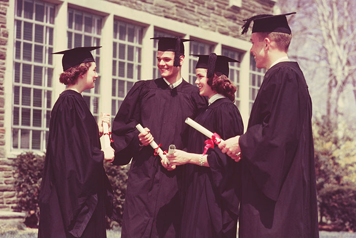 Graduates in caps and gowns holding diplomas, reflecting on life regrets and shared experiences.