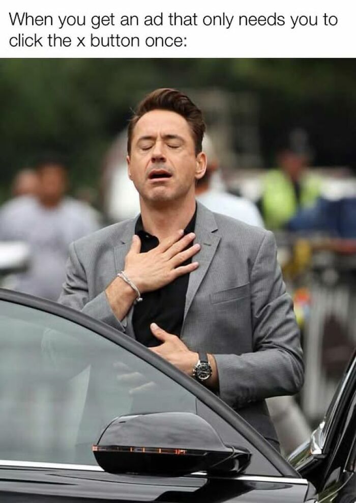 Person expressing relief, standing beside a car, embodying peak internet humor.