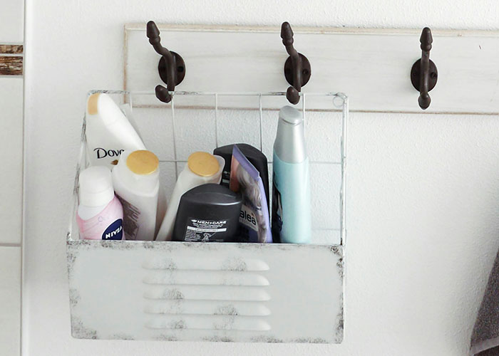 Bathroom shelf with shampoo and body wash bottles, an unusual public storage choice.