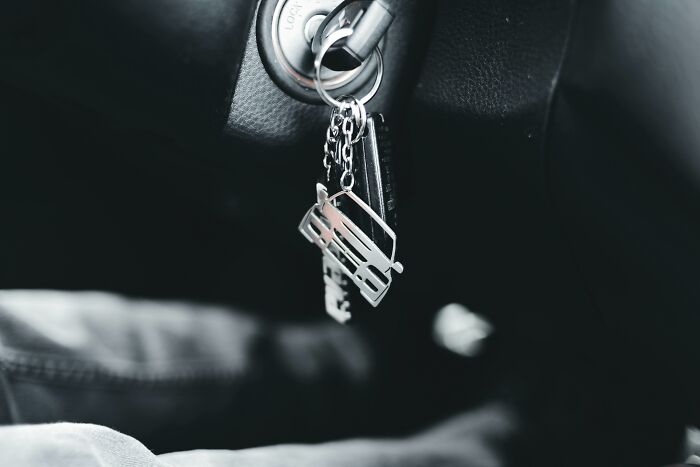 Car keychain with a sentimental van charm in ignition.