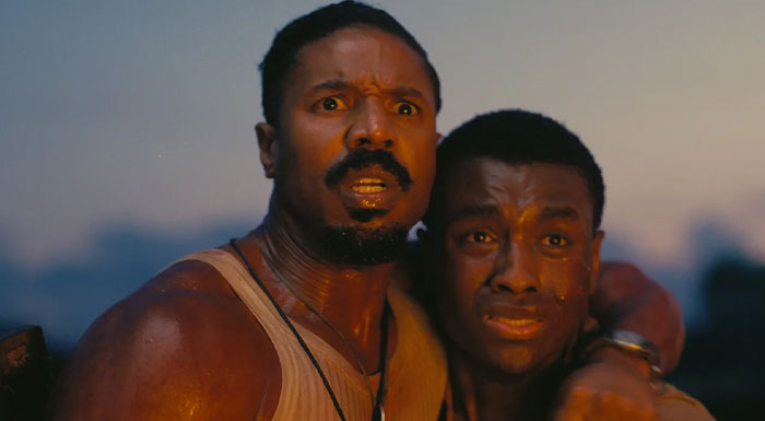 Two actors from "Sinners" in a dramatic scene, highlighting anticipated movies of 2025.