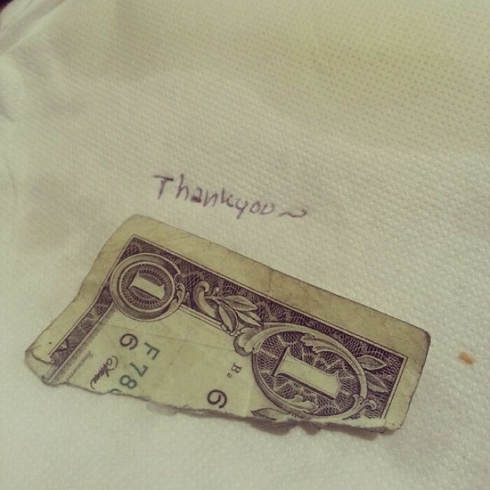 A dollar bill with "Thank you" written on a napkin, illustrating mildly infuriating server tips.