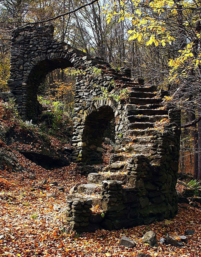 Ancient stone staircase in the forest, nature reclaiming civilization.
