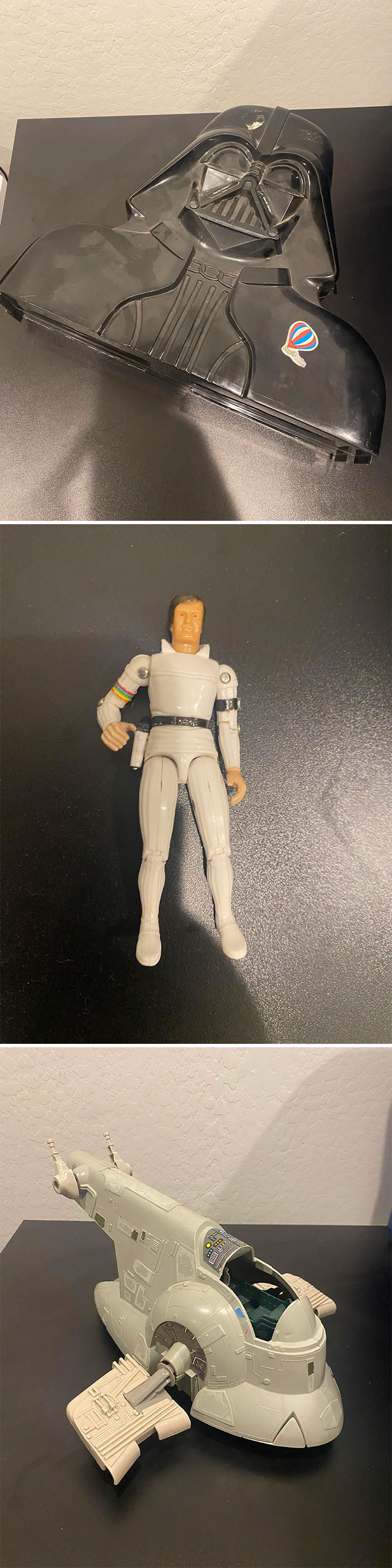 Vintage toys featuring a Darth Vader case, a sci-fi action figure, and a classic space vehicle on display.