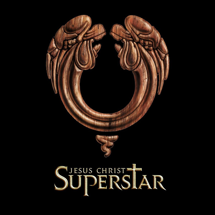 Jesus Christ Superstar logo featuring a wooden angelic design on a black background.