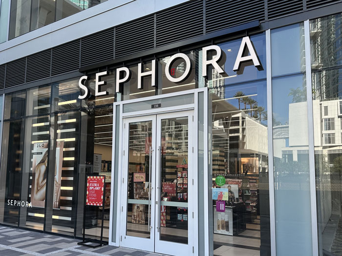 Sephora storefront with makeup displays visible through large windows. Sephora storefront with makeup displays visible through large windows.