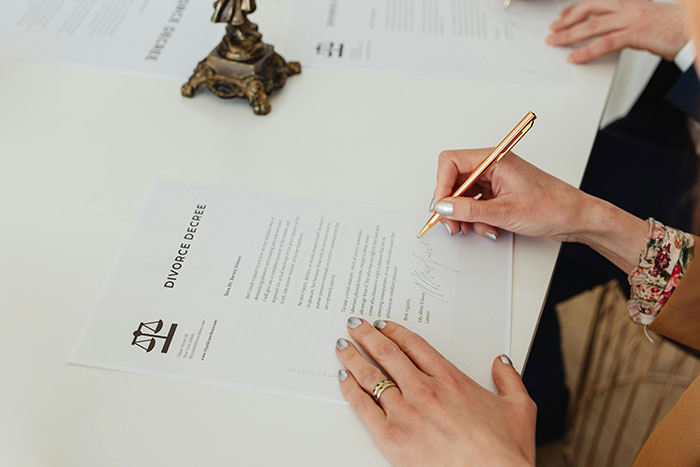 Signing of a divorce decree, highlighting family dynamics and stepmom bonding challenges. Signing of a divorce decree, highlighting family dynamics and stepmom bonding challenges.