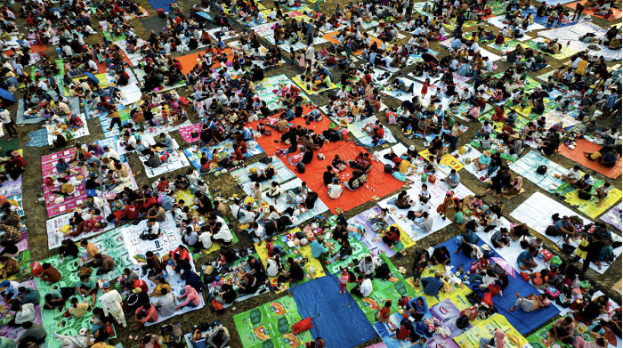 Colorful photograph of crowds of pilgrims seated on vibrant mats, shared widely on Vietnamese social media. Colorful photograph of crowds of pilgrims seated on vibrant mats, shared widely on Vietnamese social media.