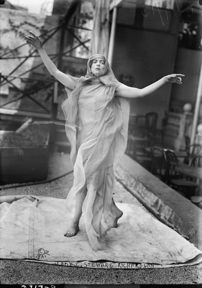 Vintage photo of a woman in flowing attire, posing dramatically; historical imagery that resonates today.