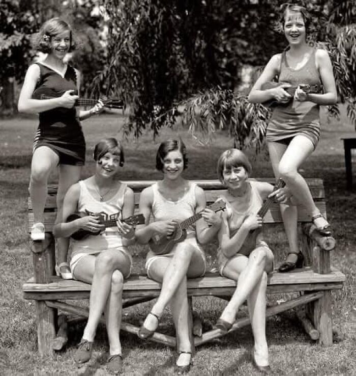 Vintage photo of women in swimsuits playing ukuleles, showcasing historical fashion and enduring cultural moments.