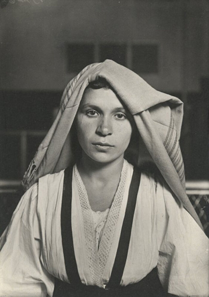 A woman from a hundred years ago wearing traditional attire, reflecting historical resonance.