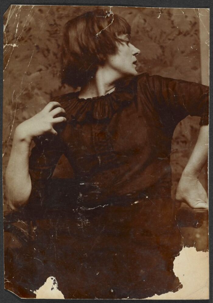 Vintage photo of a woman in profile, wearing a dark dress, evoking historical resonance.