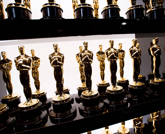 Oscars statuettes on display, associated with Whoopi Goldberg and other presenters amid fan boycott discussions. Oscars statuettes on display, associated with Whoopi Goldberg and other presenters amid fan boycott discussions.