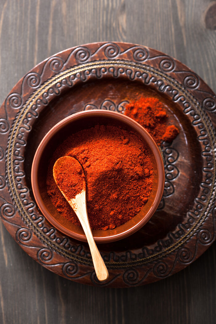 Bowl of paprika on ornate plate, showcasing an amazing ingredient often overlooked.