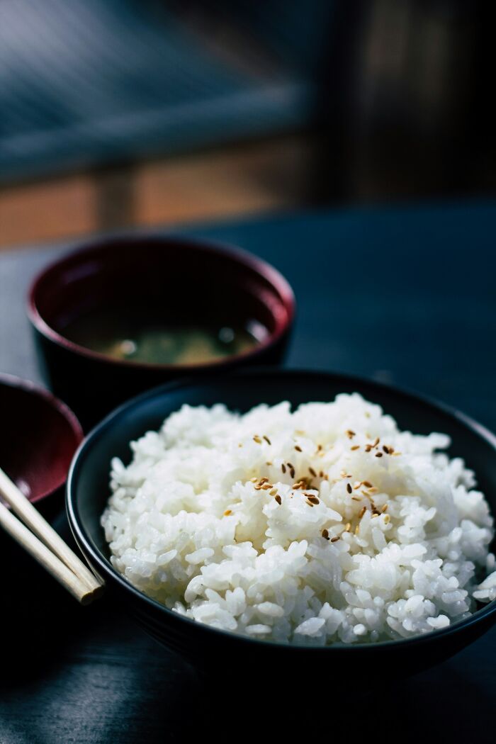 Bowl of rice garnished with sesame seeds, showcasing amazing ingredients to explore.