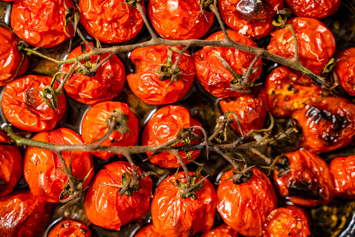 Roasted tomatoes, an amazing ingredient often overlooked, glistening on the vine with charred skins.