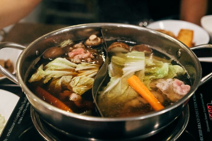 Hot pot with fresh ingredients, including cabbage, carrots, and mushrooms, showcasing amazing overlooked ingredients.