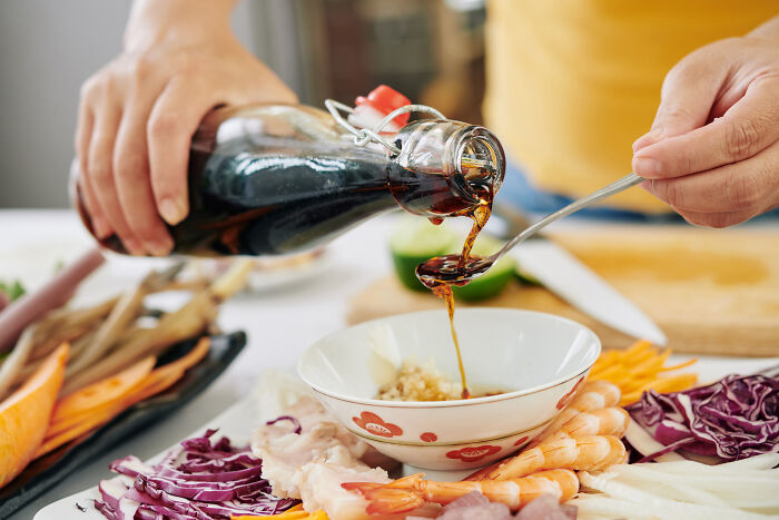 Pouring sauce over ingredients, showcasing amazing overlooked ingredients in cooking.