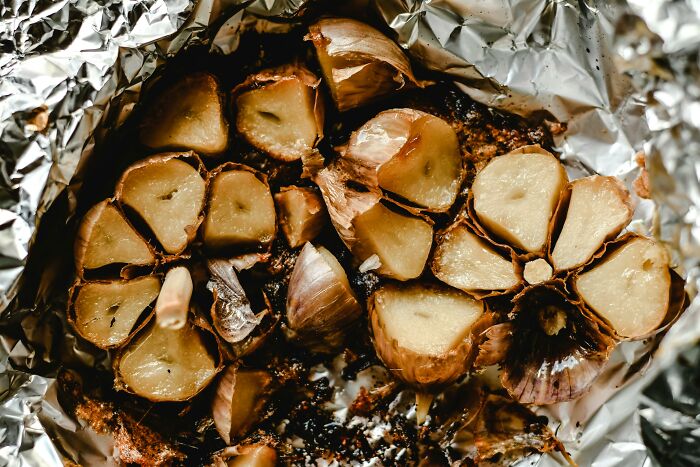 Roasted garlic cloves wrapped in foil, showcasing overlooked ingredients.