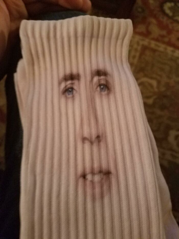 White sock with a printed face, a unique gift idea for someone who has everything.
