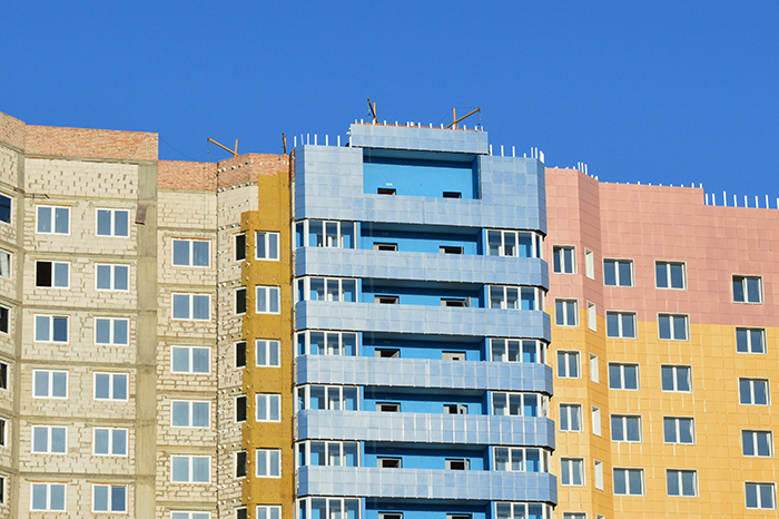 Colorful apartment buildings under clear blue skies.