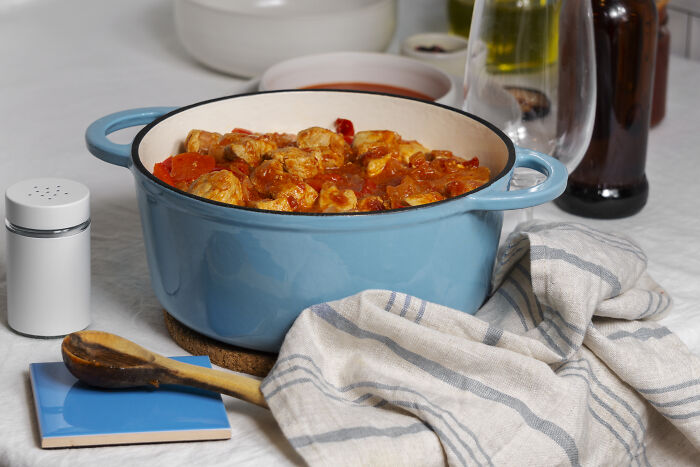 A homemade stew in a blue pot on a kitchen table, showcasing an alternative to fast food.