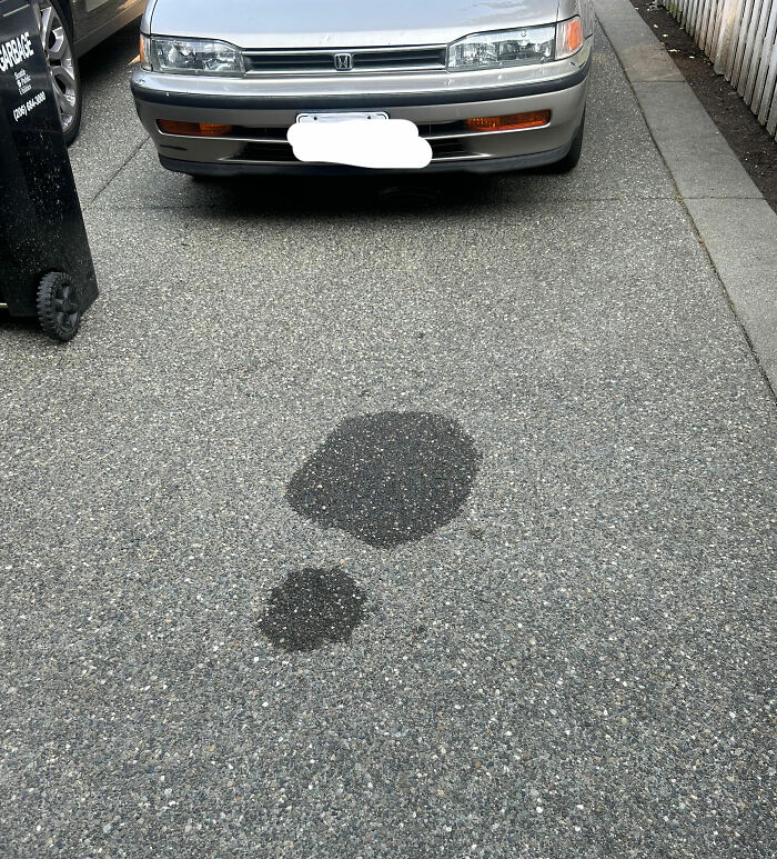 A parking spot with a stain shaped like an exclamation mark, representing a clever reverse psychology trick.