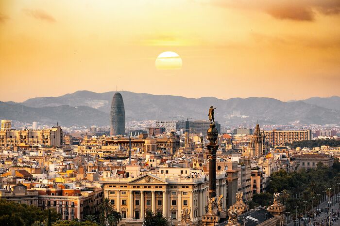 Barcelona skyline at sunset, highlighting cultural differences with historical and modern architecture.