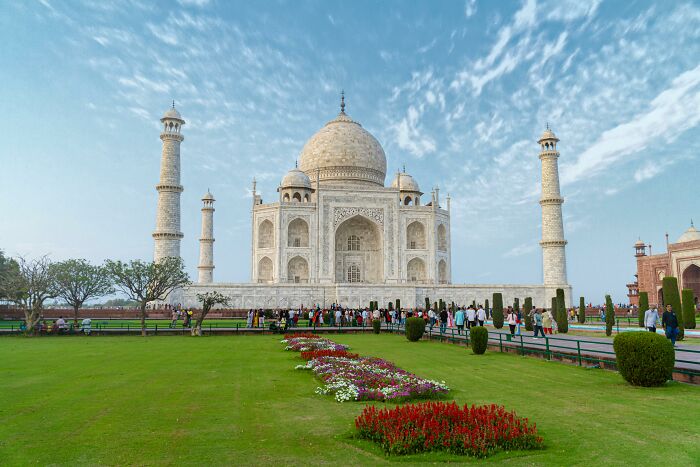 Taj Mahal under a blue sky, highlighting shocking cultural differences with its unique architecture and gardens.