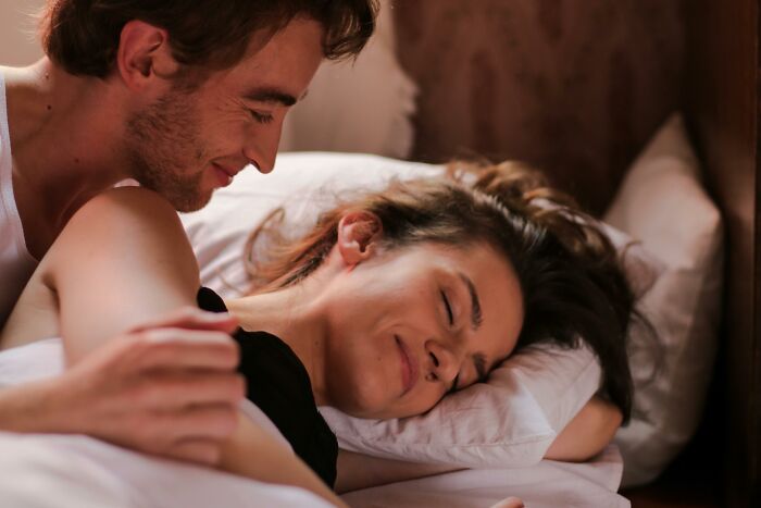 A couple sharing a tender morning moment in bed, highlighting eye-opening moments of intimacy and connection.