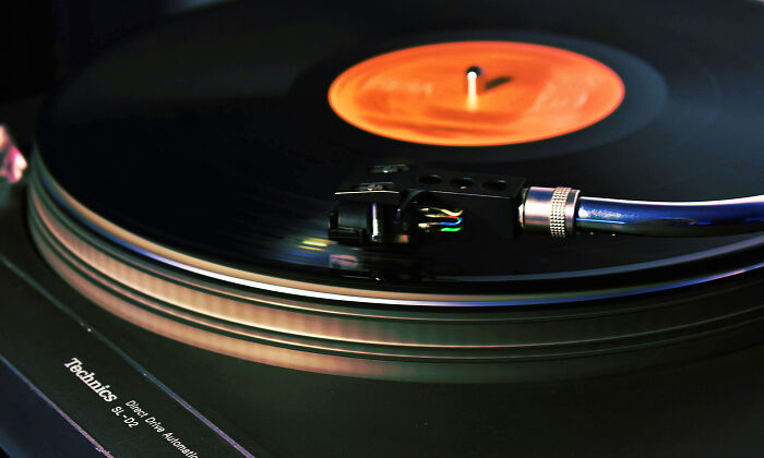 Turntable playing a vinyl record, showcasing beautifully designed durable audio equipment.