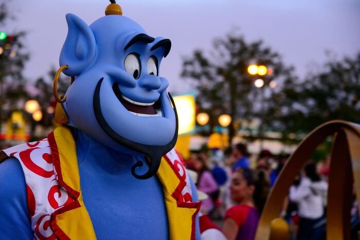 Blue character in vibrant costume at an outdoor event, capturing a pop culture moment.