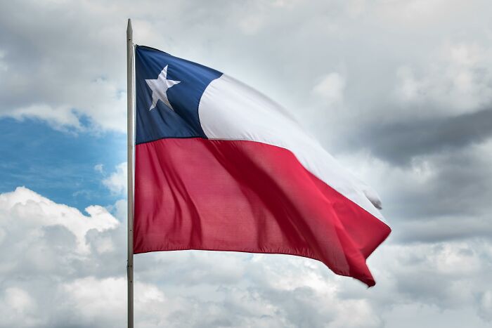 Chilean flag waving in the cloudy sky, symbolizing cultural differences.