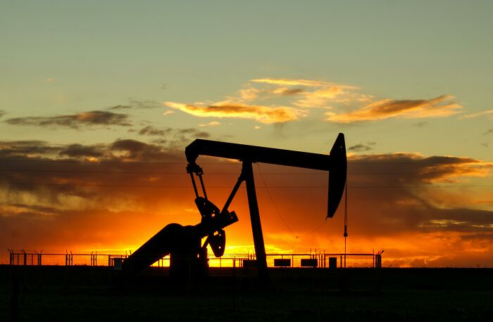 Oil pumpjack at sunset, illustrating aged predictions about future energy sources.
