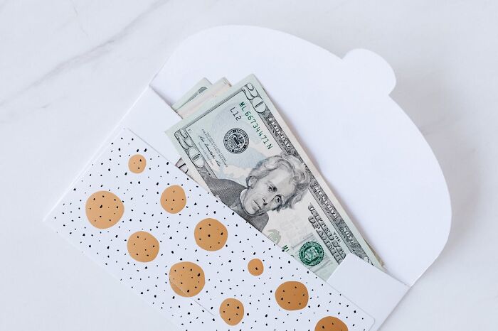 Money inside a decorative envelope, highlighting wedding guest preferences.