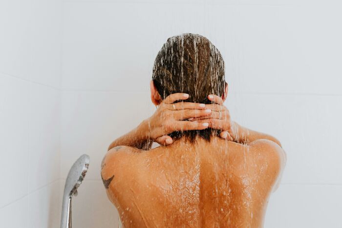 Person enjoying a shower, symbolizing remote work perks and flexibility.